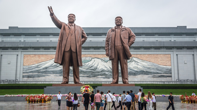 north korea statues tourists 