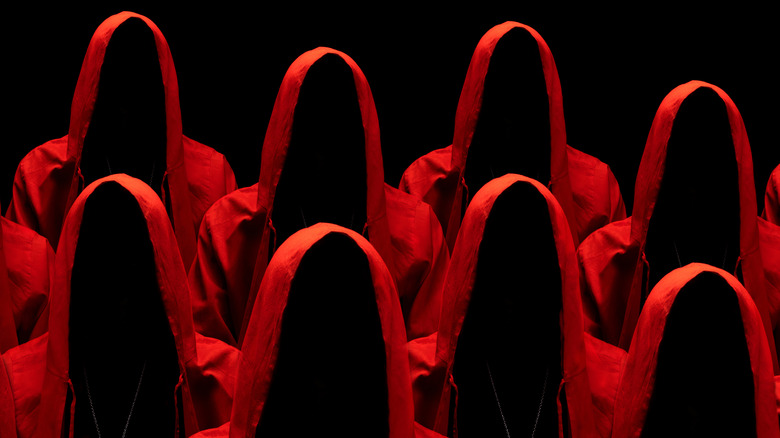 Hooded figures in red robes