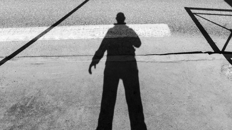 person's shadow on pavement