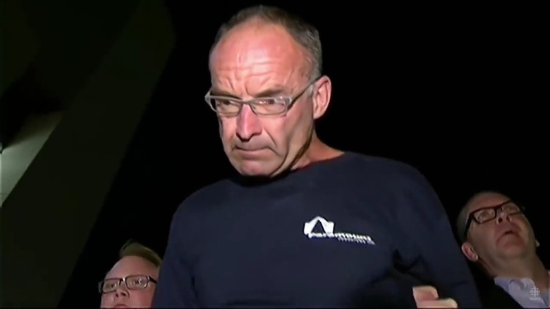 Douglas Garland looking grim while in police custody