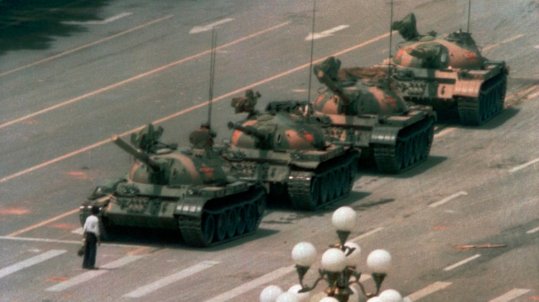 Tank Man facing off in front of four tanks