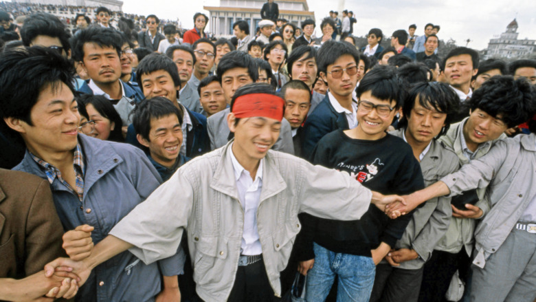 Student protesters holding hands 