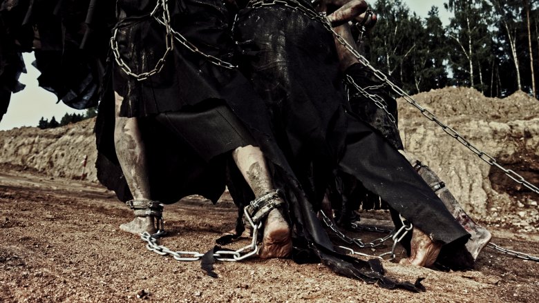 slaves walking dark robes chains