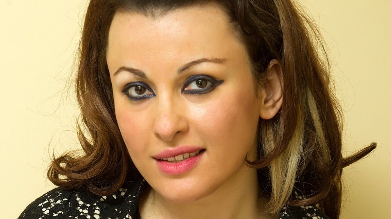 Closeup of Roxana Shirazi smiling with heavy eyeliner