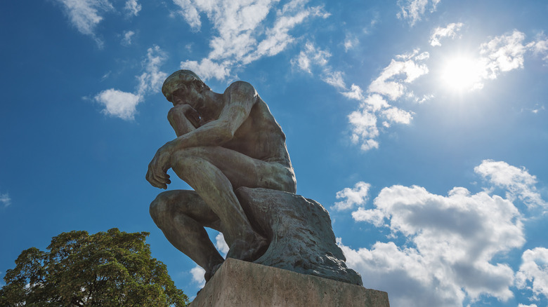 view of famous statue of Rodin's The Thinker on sunny day on July 25, 2015 in Paris, France