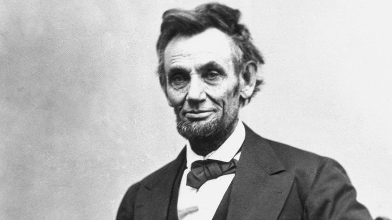 Abraham Lincoln suit sitting and smiling