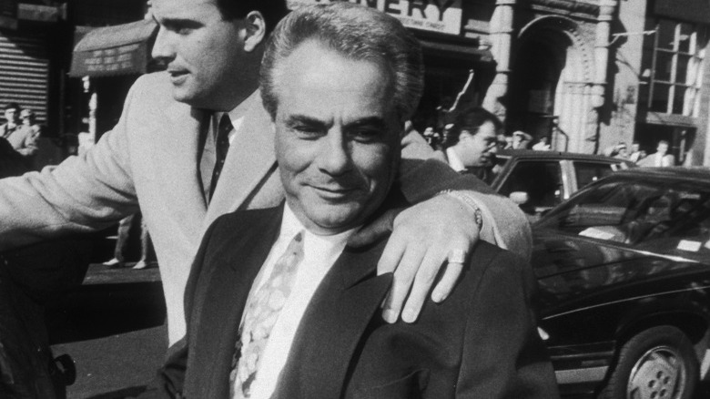 John Gotti on sidewalk smiling