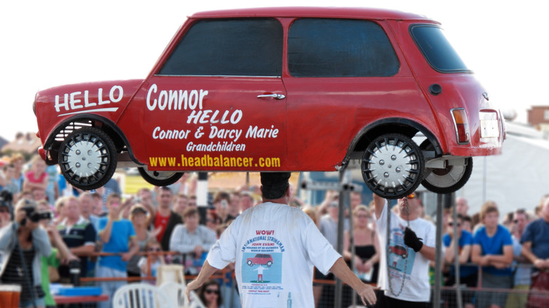 Evans balancing car on head