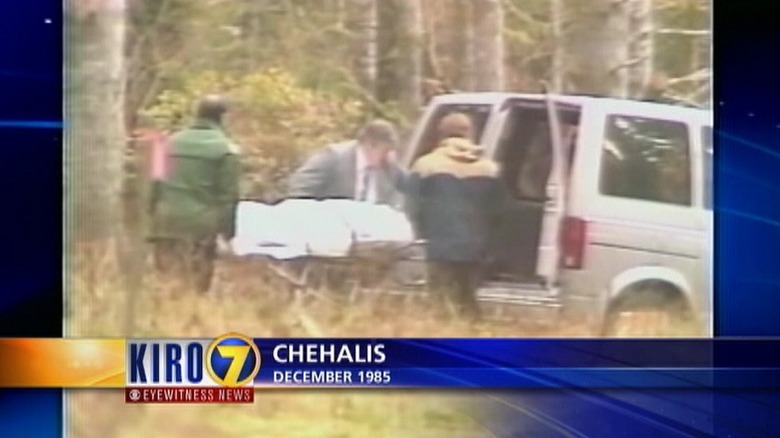 Body bag and van outside crime scene