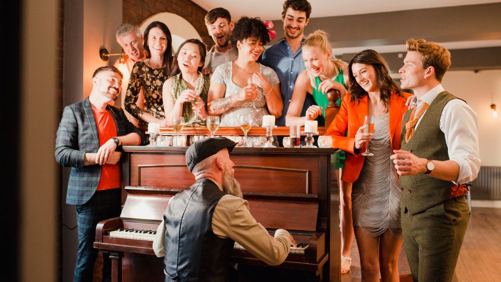 Family singing around piano