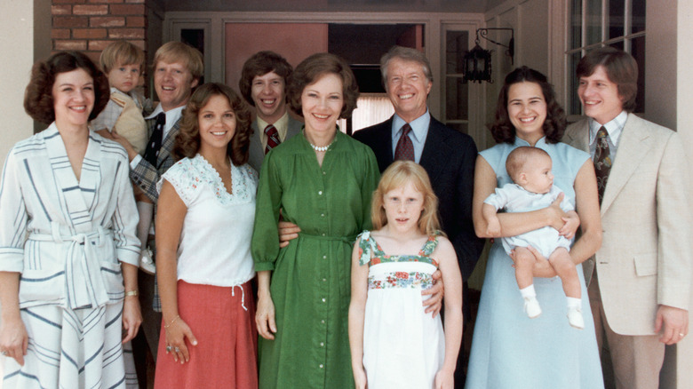 Jimmy Carter smiling with family standing in group portrait