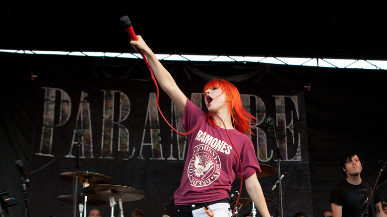 Hayley Williams on stage arm raised red hair