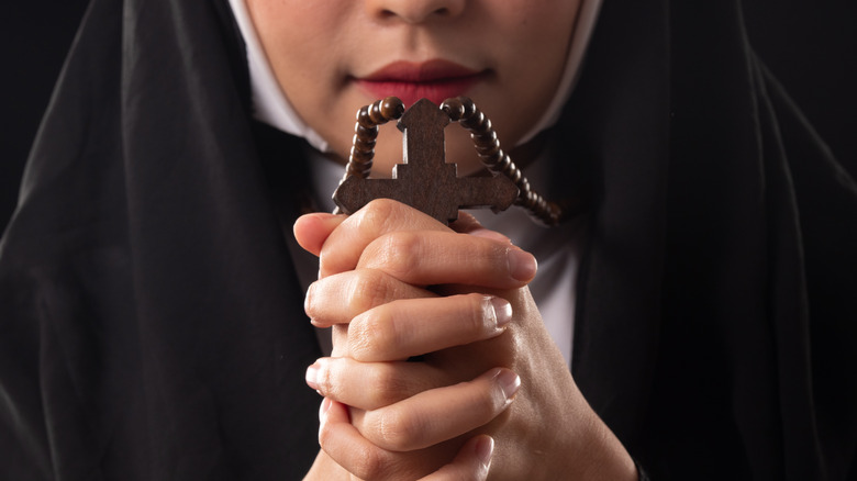 nun praying the rosary