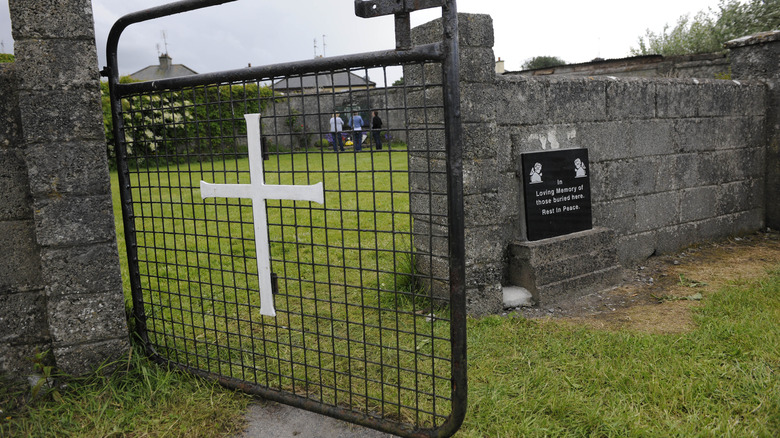 tuam mother and baby home gate with white cross