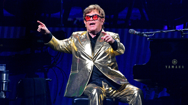 Elton John wearing a shiny outfit