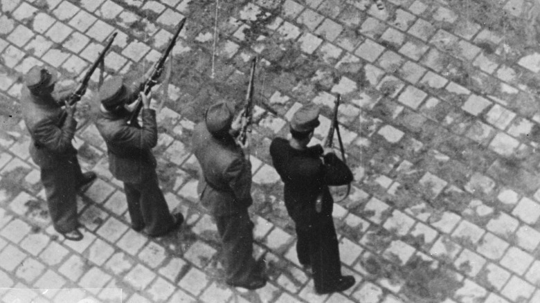 Firing squad holding guns