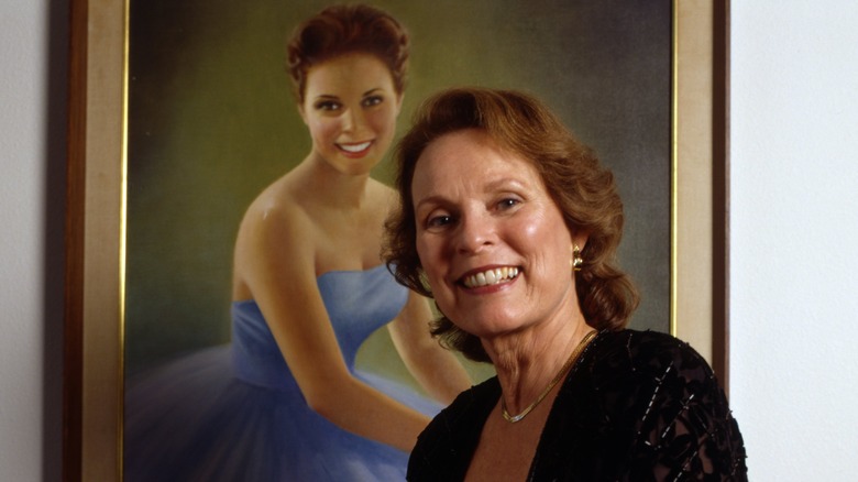 Maria Fletcher posing in front of her Miss America portrait