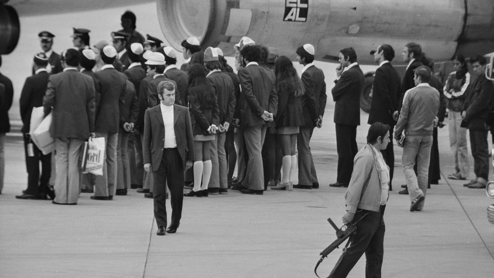 people standing on an airplane tarmac