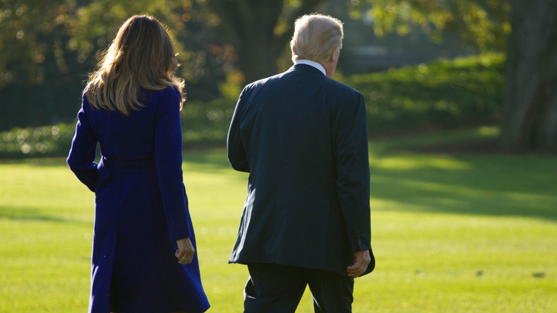 Donald and Melania Trump walking away from the camera