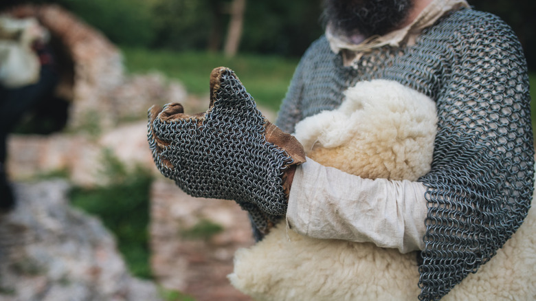 Man putting chain mail on hand