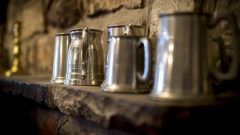 pewter tankards on shelf