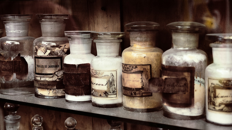 glass apothecary bottles on shelf