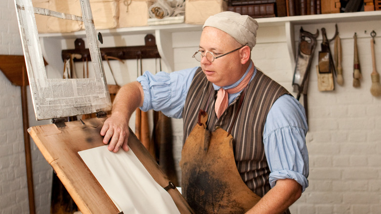 colonial reenactor with printing press