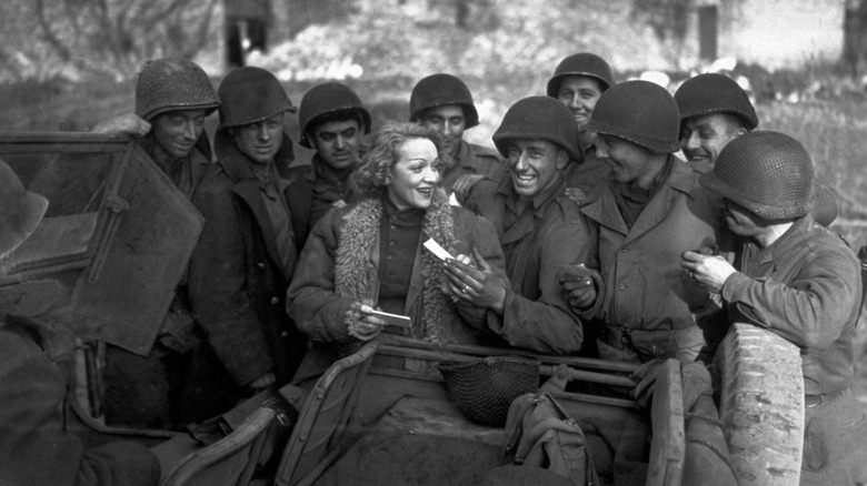 Marlene Dietrich signing autographs