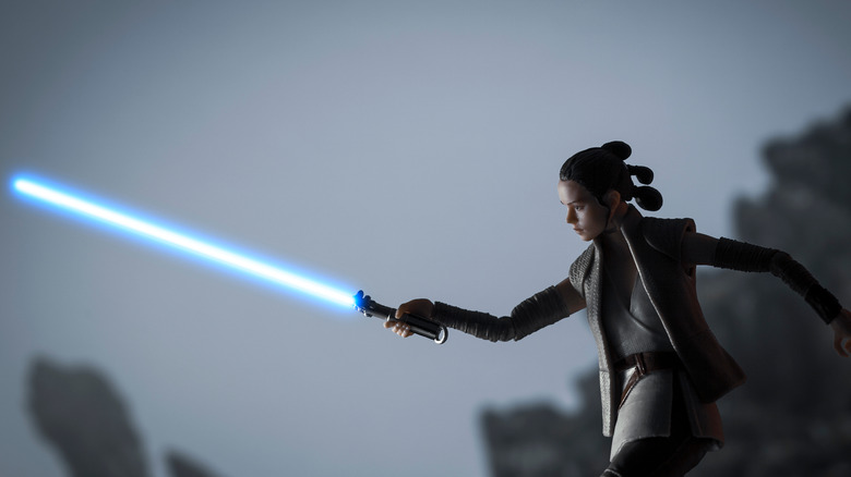 rey last jedi training holding lightsaber