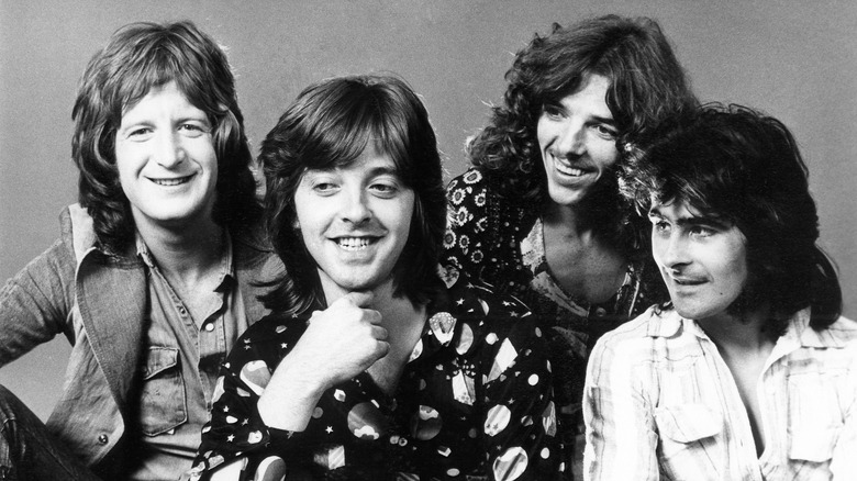 Four members of Badfinger smiling