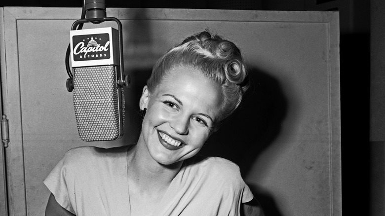 Peggy Lee smiling with microphone