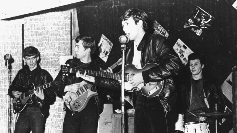 The Beatles on stage in leather jackets