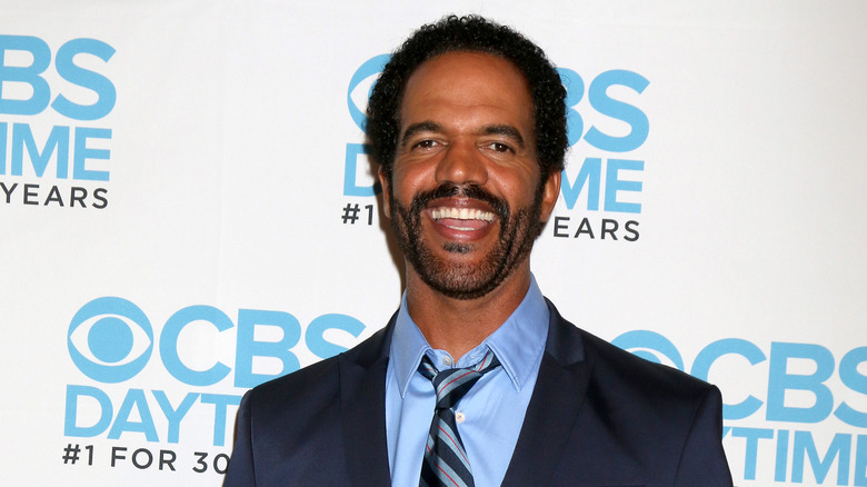 Kristoff St. John smiling in suit