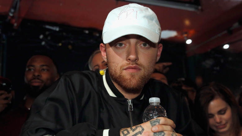 Mac Miller white baseball cap water