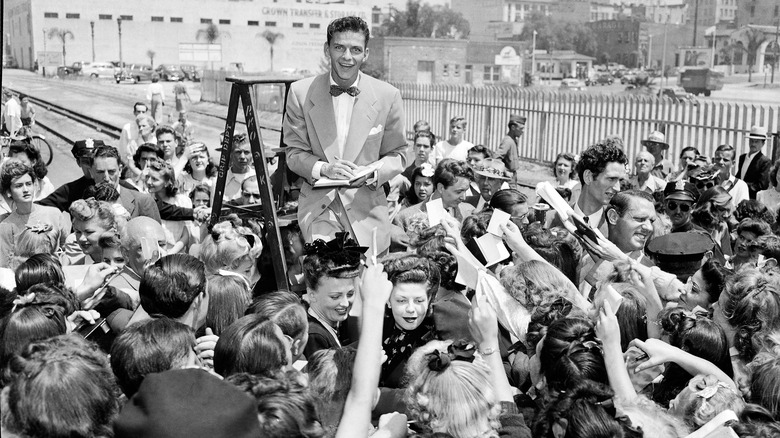 Frank Sinatra surrounded by fans