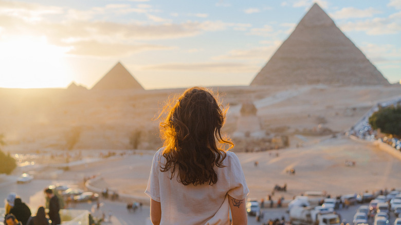 Woman gazing at pyramids