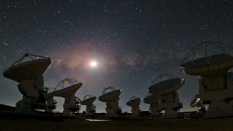 A starry sky over the ALMA radio telescope array.