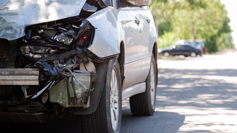 White car damaged from an accident in road