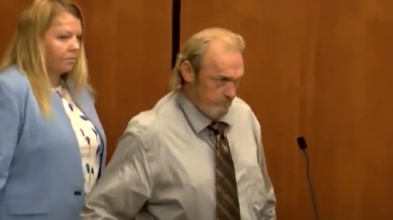 Curtis Edward Smith in court scowling long hair beard