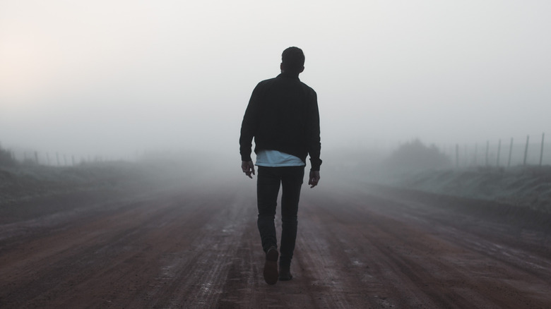 Man on misty road