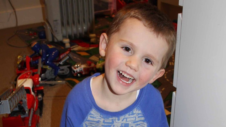 William Tyrrell smiling with toys