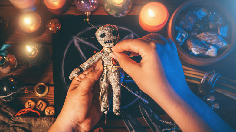 Person's hands on Voodoo doll