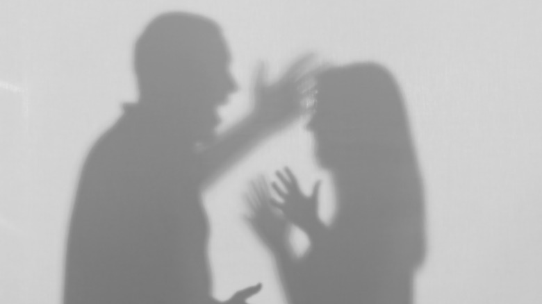 shadow of man and woman fighting