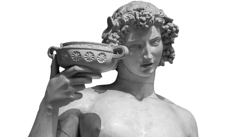 Statue Dionysus toasting wine