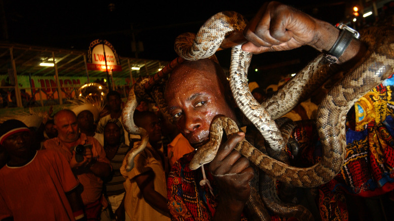 Haitian snake charmer performing