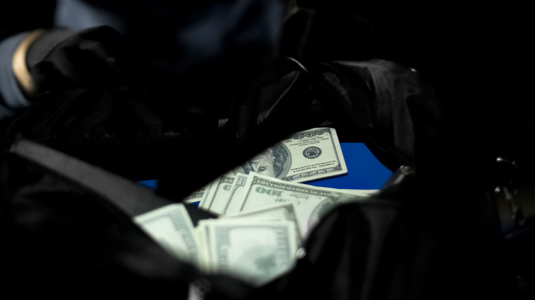 Dark figure money in bag