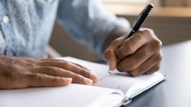 hand writing on notebook