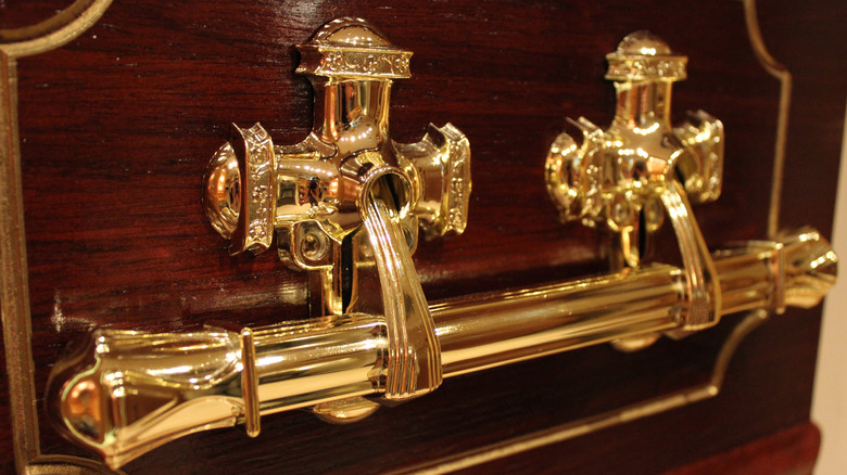 handles of a fancy wood coffin