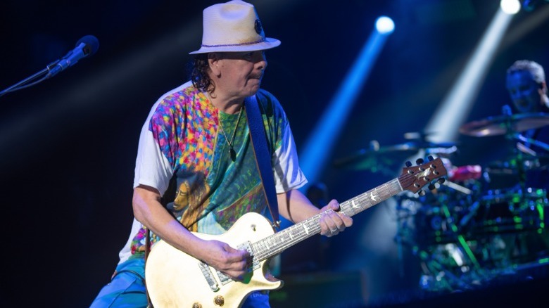 Carlos Santana playing guitar onstage