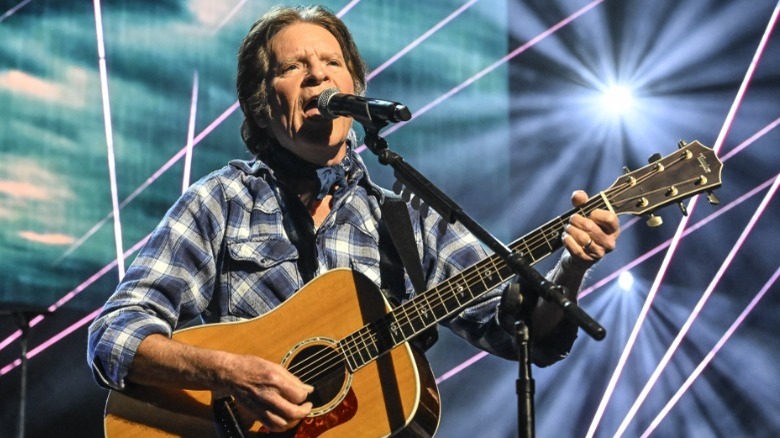 John Fogerty playing guitar onstage